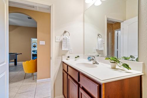 a bathroom with a sink and a mirror at Crowley Home w/Wi-Fi & Foosball in Crowley