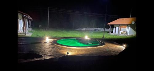 a small pond in the middle of a yard at night at Комплекс Антик in Troyan