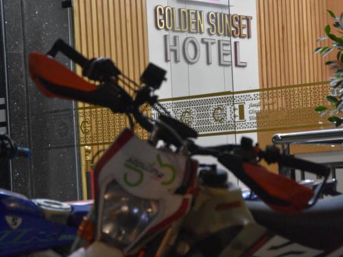 a close up of the handlebars of a bike in front of a hotel at Hotel Golden Sunset Dakhla in Dakhla