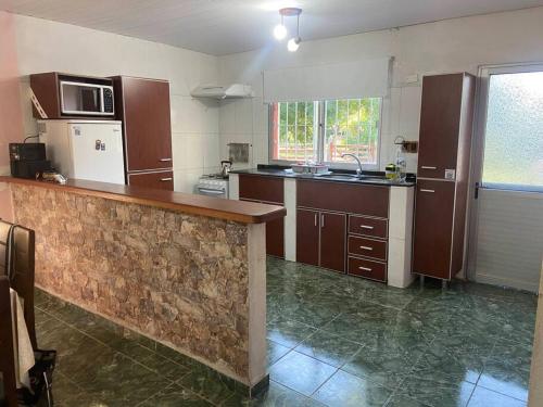 a large kitchen with a counter in a room at Sin Pensarlo 