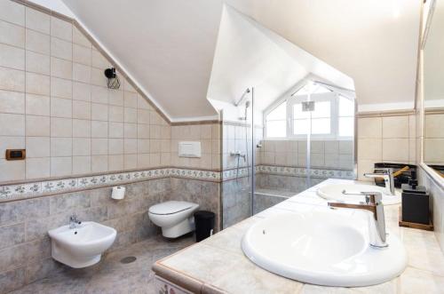 a bathroom with a sink and a toilet and a sink at CASA LALI in La Laguna