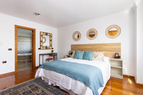 a bedroom with a large bed and a bathroom at CASA LALI in La Laguna