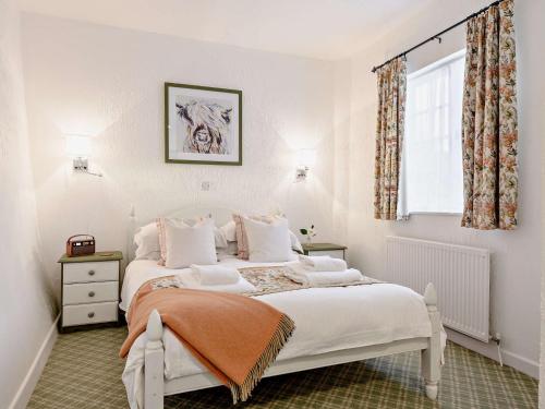 a bedroom with a white bed and a window at 1 Bed in Minehead 90923 in Minehead