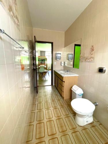 a bathroom with a toilet and a sink at Jardim Botânico House in Curitiba