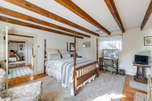 a bedroom with a bed and a television in a room at Terre Haute Manor Farmhouse with Gardens and Deck! in Midlothian