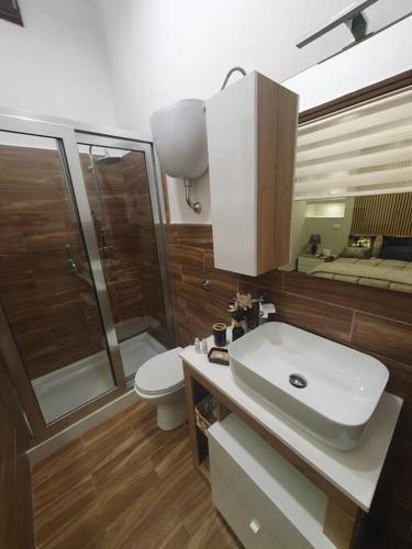 a bathroom with a sink and a shower and a toilet at My Dream House 386 in Angri