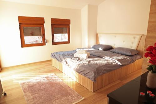 a bedroom with a bed with pillows on it at Prizren Apartment's in Prizren