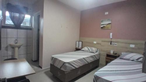 Una cama o camas en una habitación de Hotel Faf's Interlagos - SP