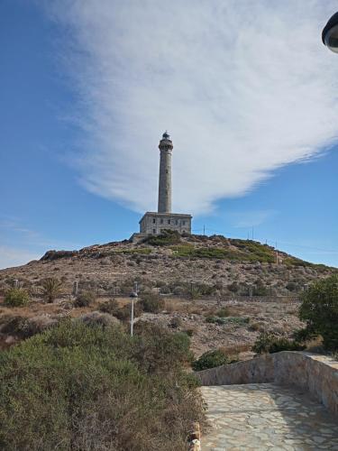 a lighthouse sitting on top of a hill at El paraíso del sol in Cartagena