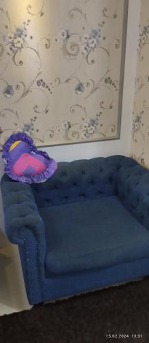 a blue couch with a pillow on top of it at Michalesma in Baku