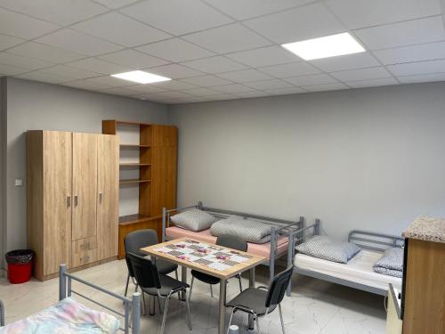 a waiting room with a table and chairs at Hostel ELDORADO in Końskie