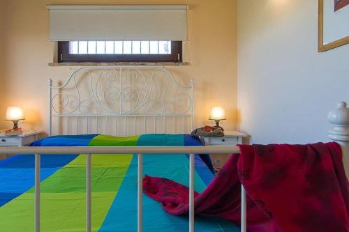 una camera da letto con un letto con una coperta colorata di 5 bedrooms house with private pool terrace and wifi at Ripatransone a Cossignano
