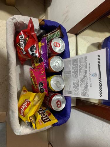 a bunch of soda cans in a basket on a counter at Hotel Puerto México Aeropuerto in Mexico City