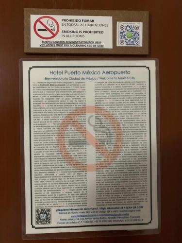 a sign on a wall with a symbol on it at Hotel Puerto México Aeropuerto in Mexico City