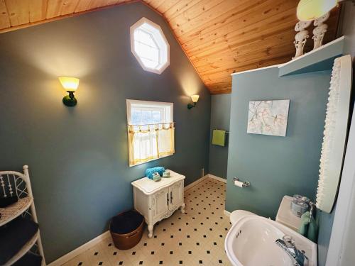 a small bathroom with a sink and a window at Red Lodge Town Cottage in Red Lodge