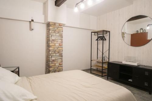 a bedroom with a bed and a mirror at Wellness & Comfort with Indoor Sauna - Close to Olympic Games in Saint-Ouen