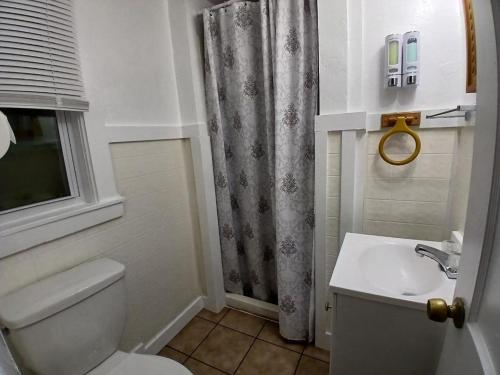 a bathroom with a toilet and a sink at Jonathan Edwards Motel in Dennis Port