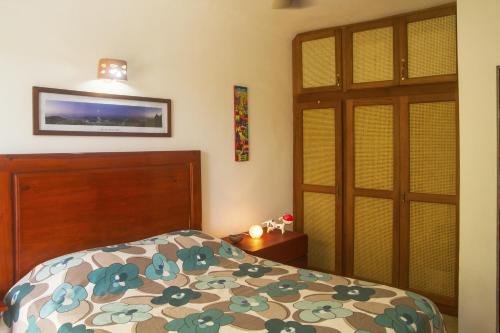 a bedroom with a bed and a tv on the wall at Royal Residence Apartment Condos in Cabarete