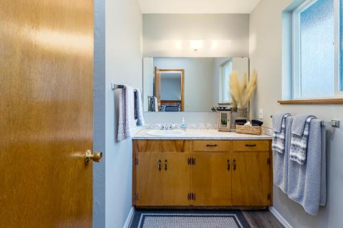 a bathroom with a sink and a mirror at Pendleton House - 2 King Beds/EV charger in Walla Walla