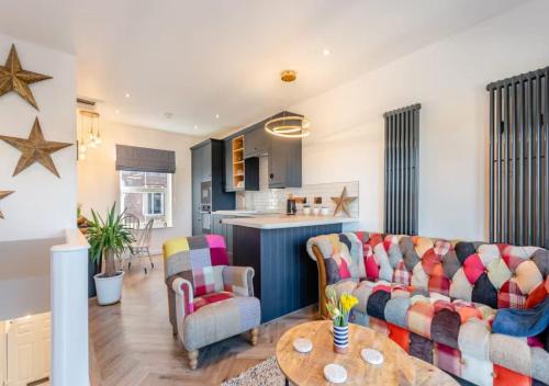 a living room with a couch and a table at Wye Knot - Boutique 2 Bedroom Town House in Wilton