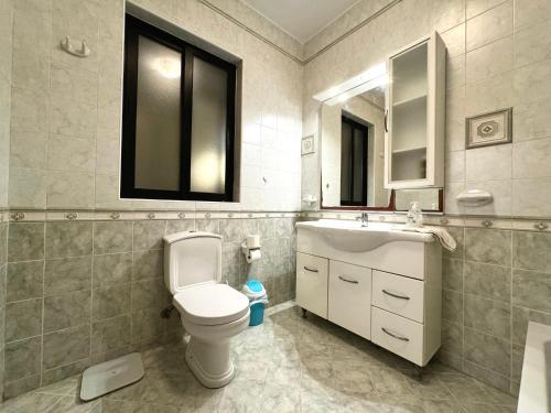 a bathroom with a toilet and a sink and a mirror at Holiday Home in St. Paul’s Bay in St Paul's Bay