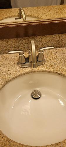 a sink with a faucet in a bathroom at 2417 at Oceanfront Resort Lihue Kauai Beach Drive Private Condo in Lihue