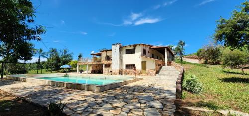 uma imagem de uma casa com piscina em Fazenda Araras Eco Turismo - Acesso a cachoeira Araras em Pirenópolis