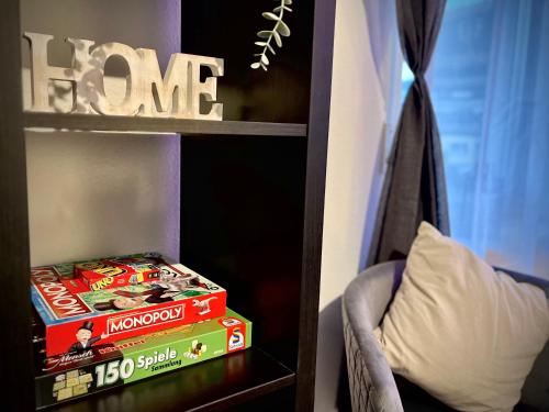 a book shelf with two boxes of food on it at G&G Luxury Apartment am Stadtpark Bendorf in Bendorf