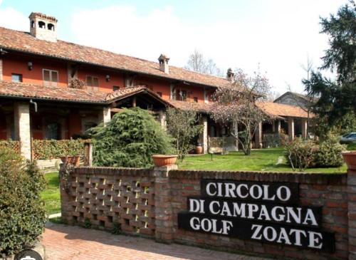 a house with a sign in front of it at ROYAL MILANO LINATE APARTMENTS in Pantigliate