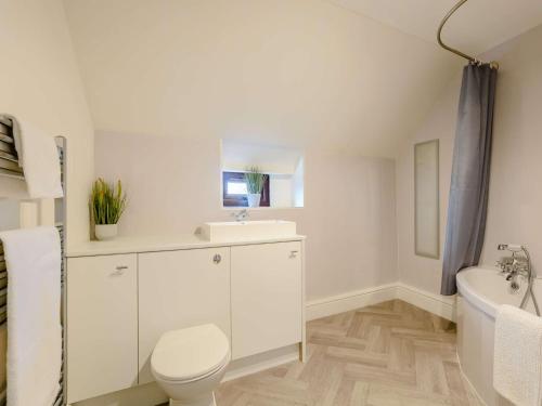 a white bathroom with a toilet and a sink at 2 Bed in Pickering 88957 in Newton