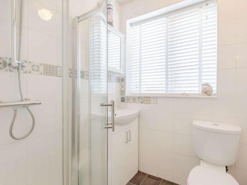 a white bathroom with a shower and a toilet at 1 Bed in Broadstairs 89359 in Broadstairs