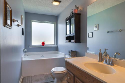 een badkamer met een wastafel, een toilet en een raam bij Charming Country Home with Deck - 20 Mi to Franklin in Columbia
