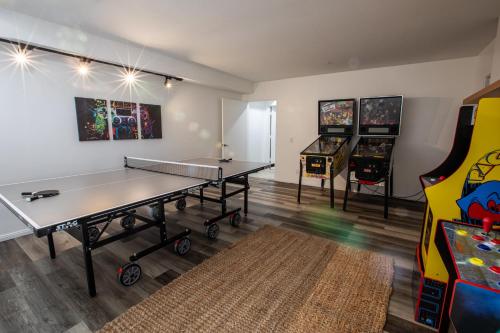 a room with a ping pong table and a game room at Elite Retreat! Hot Tub, Arcade, & Theater. 6 Beds! in Encinitas