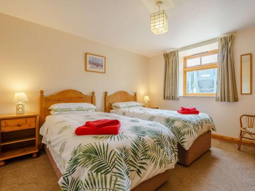 - une chambre avec 2 lits dotés d'oreillers rouges dans l'établissement 2 Bed in Helmsley TGCHF, à Chop Gate