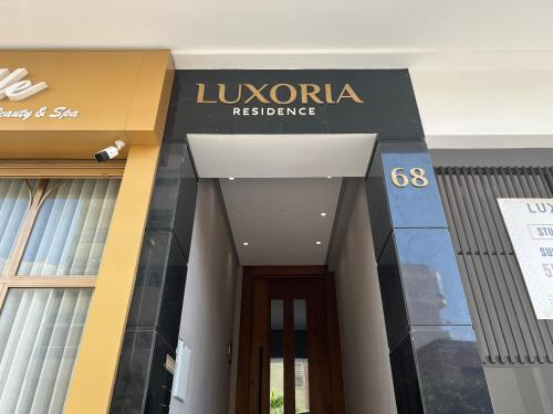 a building with a sign that reads luxoria resistance at Luxoria by SHORTSTAYCASA- New & Chic in the heart of town in Casablanca