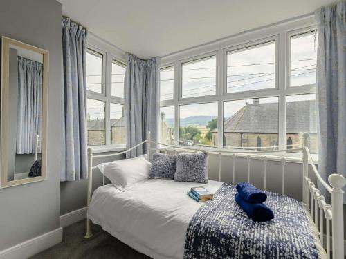 a bedroom with a bed and a large window at 2 bed property in Rothbury Northumberland 89502 in Thropton