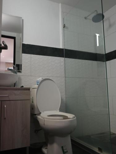 a bathroom with a toilet and a glass shower at Hotel Urban Cholula in Cholula
