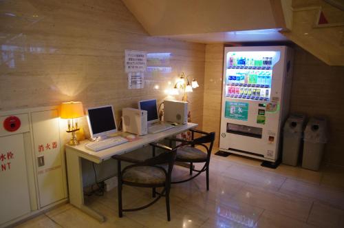 a room with three computers on a desk with a refrigerator at Gifu Castle Inn in Gifu
