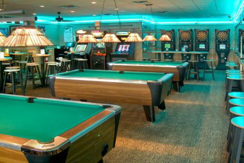 a row of pool tables in a billiard room at Holiday Inn Express Hotel & Suites-St. Paul by IHG in Vadnais Heights