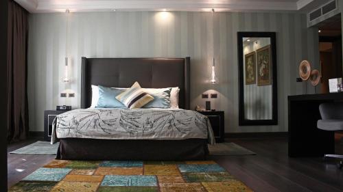 a bedroom with a large bed with blue pillows at InterContinental Santiago by IHG in Santiago
