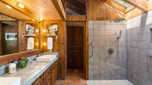 a bathroom with two sinks and a shower at Summers House in Sonoma