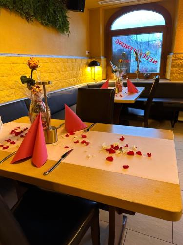 a table with red paper napkins on it in a restaurant at Gasthaus Hasen - Grill Masters in Geislingen