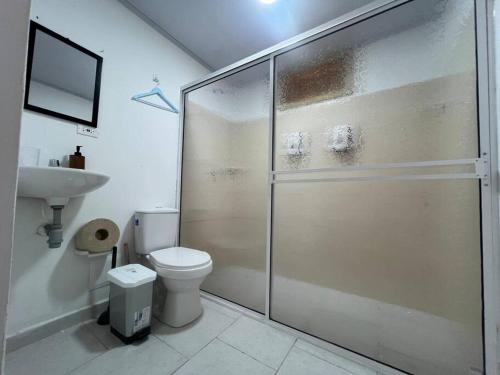 a bathroom with a shower and a toilet and a sink at Inspire Country House BY JR in Providencia