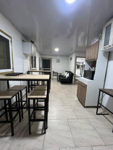 a kitchen with tables and chairs in a room at JAZMIN HOUSEs JR in Providencia
