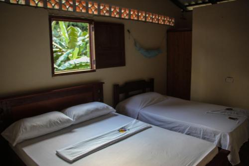 Posteľ alebo postele v izbe v ubytovaní Posada Las Palmera Huina