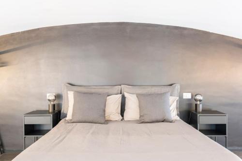 a large bed with two nightstands and a large headboard at Diaz Novantuno - Luxury Apartments Como City Center in Como