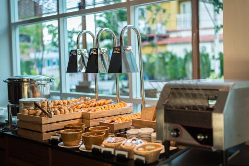 un comptoir avec plein de beignets et de beignets. dans l'établissement Fishermens Harbour Urban Resort - SHA Extra Plus, à Patong Beach