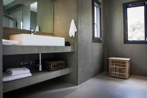a bathroom with a sink and a mirror at Christina by Vintage Travel in Spartia
