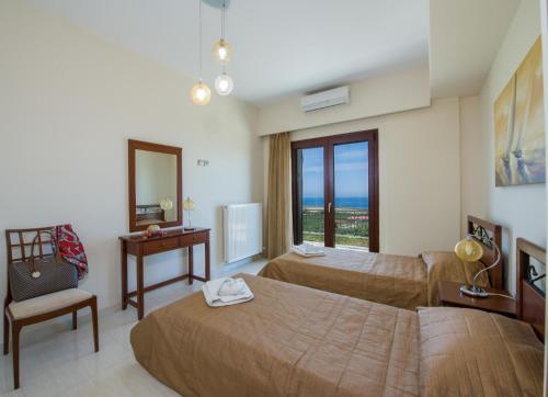 a hotel room with two beds and a mirror at Iliada by Vintage Travel in Maleme