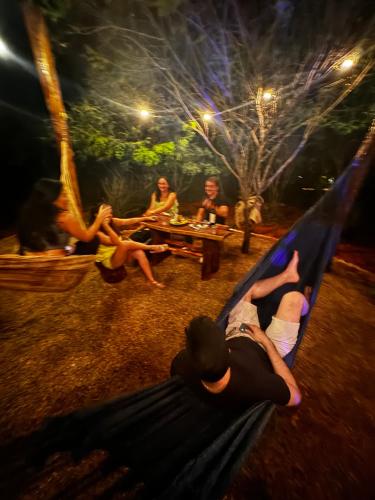 a group of people laying on a hammock at Sertão do Luar in Jurubeba